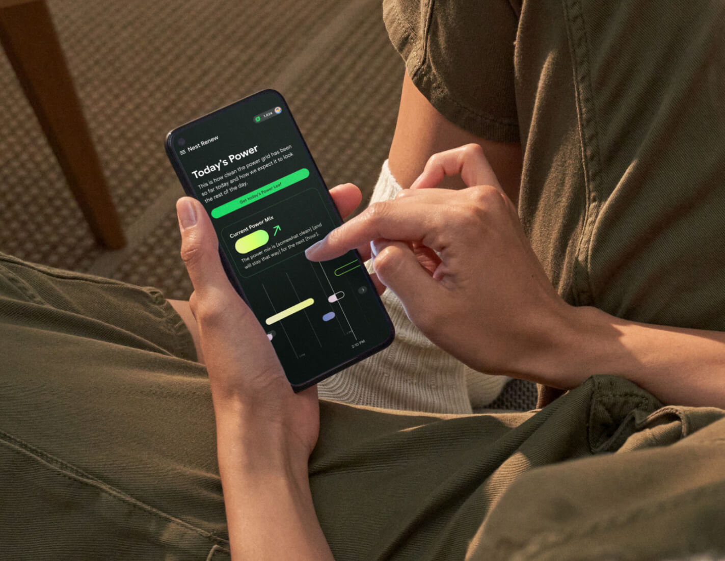 An image of a person viewing the mobile Nest dashboard on their phone.